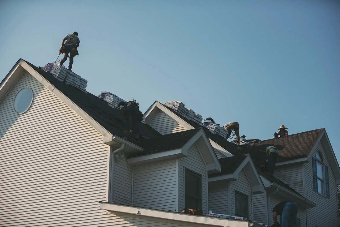 They are standing on the roofing company.